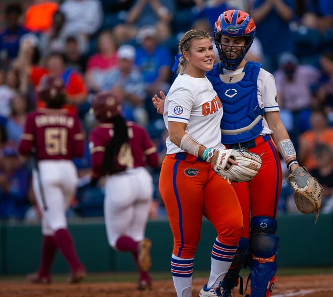 Florida Gators relief pitcher Rylee Trlicek (44) gets a hug from Florida Gators catcher Sarah Longley (52) after closing out the fourth inning. The Florida women’s softball team hosted FSU at Katie Seashole Pressly Stadium in Gainesville, FL on Wednesday, May 3, 2023. The Seminoles defeated the Gators 8-7.  [Doug Engle/Gainesville Sun]