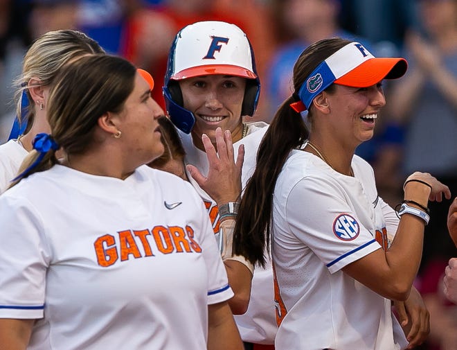 Florida Gators infielder Skylar Wallace (17) center, is greeted at home plate by teammates after hitting a home run in the bottom of the fourth to go ahead of the Seminoles 4-3. The Florida women’s softball team hosted FSU at Katie Seashole Pressly Stadium in Gainesville, FL on Wednesday, May 3, 2023. The Seminoles defeated the Gators 8-7.  [Doug Engle/Gainesville Sun]