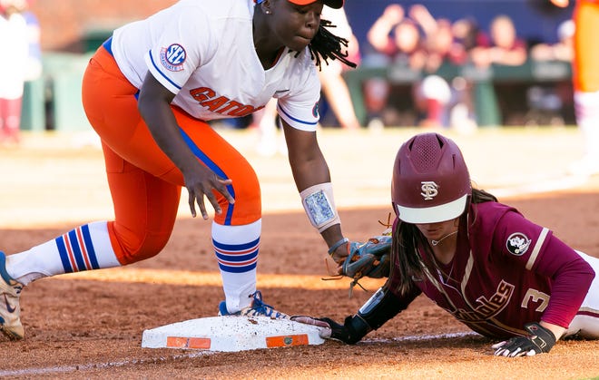 Florida St. Seminoles infielder Bethaney Keen (3) beats the throw to third as Florida Gators third baseman Charla Echols (4) gets the ball late. The Florida women’s softball team hosted FSU at Katie Seashole Pressly Stadium in Gainesville, FL on Wednesday, May 3, 2023. The Seminoles defeated the Gators 8-7.  [Doug Engle/Gainesville Sun]