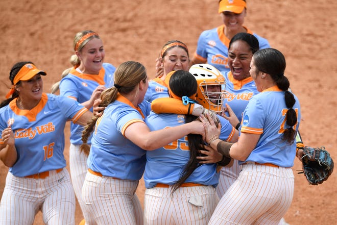 Tennessee's Payton Gottshall (33) is rushed by her teammates after striking out Texas' last batter to win the NCAA super regional in Knoxville,Tenn. on Saturday, May 27, 2023.