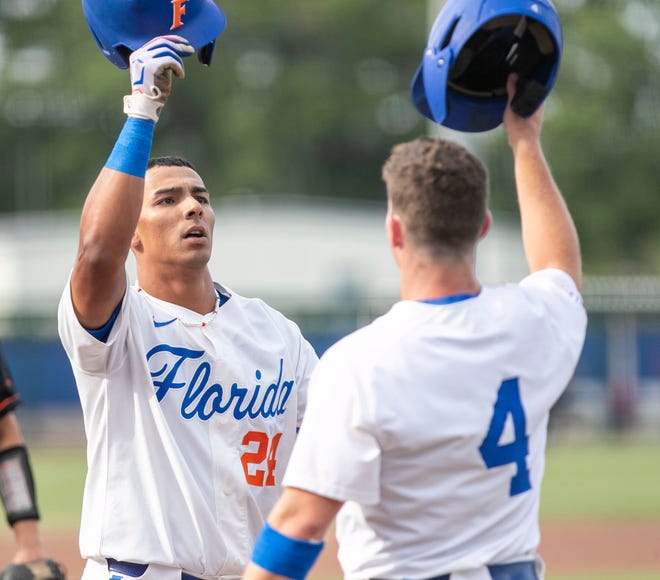 Florida's infielder Josh Rivera (24) celebrates his two run homer with Cade Kurland (4) in the bottom of the first inning against FAMU in the NCAA Regionals, Friday, June 2, 2023, at Condron Family Ballpark in Gainesville, Florida. The Gators shut out the Rattlers 3-0, and face Texas Tech Saturday. [Cyndi Chambers/ Gainesville Sun] 2023