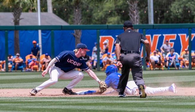 Gators outfielder Michael Robertson (11) steals second under the tag by Huskies infielder Paul Tammaro (23) in the bottom of the seventh against U Conn in NCAA Regionals, Sunday, June 4, 2023, at Condron Family Ballpark in Gainesville, Florida. Florida beat U Conn 8-2. [Cyndi Chambers/ Gainesville Sun] 2023
