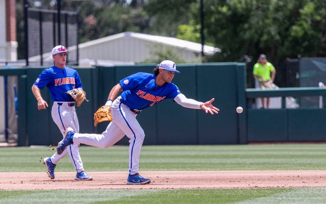 Gators utility Jac Caglianone (14) with the toss to first for the out on Huskies Bryan Padilla (1) in the top of the fourth inning in NCAA Regionals, Sunday, June 4, 2023, at Condron Family Ballpark in Gainesville, Florida. Florida beat U Conn 8-2. [Cyndi Chambers/ Gainesville Sun] 2023