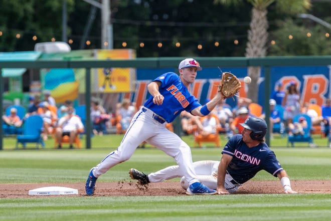 Huskies infielder David Smith (10) steals second under the tag by Gators infielder Cade Kurland (4) in the top of the first inning in NCAA Regionals, Sunday, June 4, 2023, at Condron Family Ballpark in Gainesville, Florida. Florida beat U Conn 8-2. [Cyndi Chambers/ Gainesville Sun] 2023