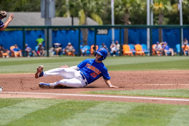 Gators catcher Luke Heyman (28) is safe at third in the bottom of the second inning against U Conn in NCAA Regionals, Sunday, June 4, 2023, at Condron Family Ballpark in Gainesville, Florida. Florida beat U Conn 8-2. [Cyndi Chambers/ Gainesville Sun] 2023