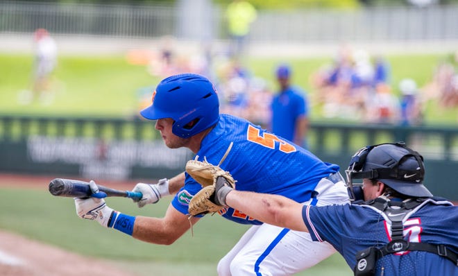 Gators infielder Colby Halter (5) bunts the ball in the bottom of the fifth against U Conn in NCAA Regionals, Sunday, June 4, 2023, at Condron Family Ballpark in Gainesville, Florida. Florida beat U Conn 8-2. [Cyndi Chambers/ Gainesville Sun] 2023