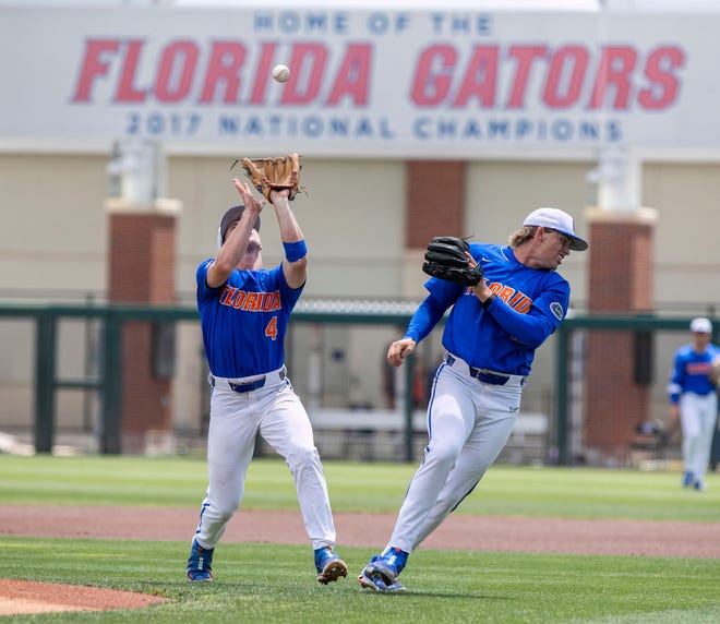 Gators pitcher Hurston Waldrep (12) moves out of the way for Gators infielder Cade Kurland (4) to make the catch on Huskies infielder Paul TammaroÕs (23) pop-up on the bottom of the first inning in NCAA Regionals, Sunday, June 4, 2023, at Condron Family Ballpark in Gainesville, Florida. Florida beat U Conn 8-2. [Cyndi Chambers/ Gainesville Sun] 2023