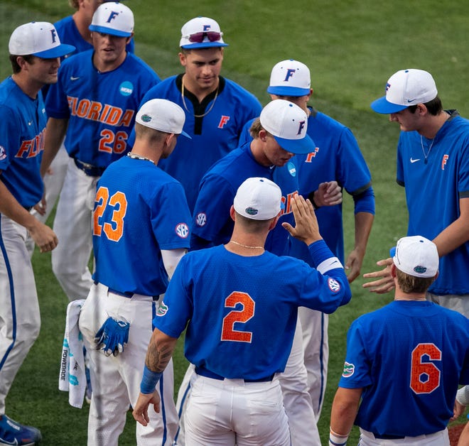 Gators pitcher Hurston Waldrep (12) is greeted by teammates after pitching against South Carolina in Game 2 of the NCAA Super Regionals, Saturday, June 10, 2023, at Condron Family Ballpark in Gainesville, Florida. The Gators beat the Gamecocks 4-0 and are headed to the College World Series in Omaha.  [Cyndi Chambers/ Gainesville Sun] 2023