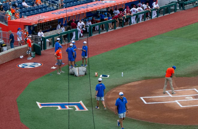 The grounds crew for the Gators prepares for Game 2 of NCAA Super Regionals between the Gators and Gamecocks. The start of the game was delayed due to expected bad weather Saturday, June 10, 2023, at Condron Family Ballpark in Gainesville, Florida. [Cyndi Chambers/ Gainesville Sun] 2023