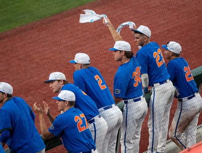 Gators cheer from there dugout in the bottom of the ninth inning against South Carolina in Game 2 of the NCAA Super Regionals,Saturday, June 10, 2023, at Condron Family Ballpark in Gainesville, Florida. The Gators beat the Gamecocks 4-0 and are headed to the College World Series in Omaha.  [Cyndi Chambers/ Gainesville Sun] 2023