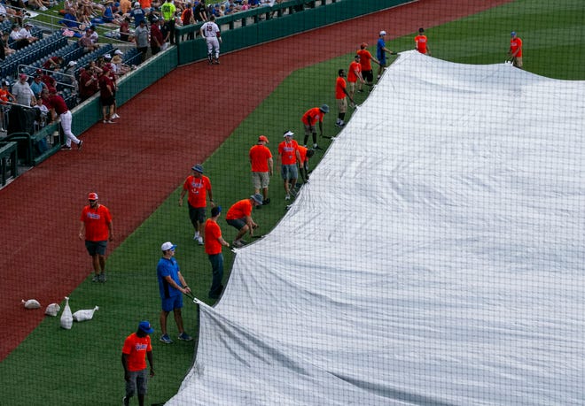The grounds crew for the Gators pulls the tarp over the field  before the start of Game 2 of NCAA Super Regionals between Florida and South Carolina due to expected bad weather, Saturday, June 10, 2023, at Condron Family Ballpark in Gainesville, Florida. [Cyndi Chambers/ Gainesville Sun] 2023